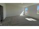 Well-lit bedroom with carpet flooring and two windows at 150 Chestnut Oak Ln, Lillington, NC 27546