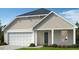 Two-story craftsman style home with neutral siding and a two-car garage at 150 Chestnut Oak Ln, Lillington, NC 27546