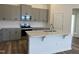 Modern kitchen with gray cabinets, quartz countertops and island at 150 Chestnut Oak Ln, Lillington, NC 27546