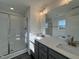 Modern bathroom with gray vanity, quartz countertop, and a walk-in shower at 175 W Saltgrass Ln, Smithfield, NC 27577