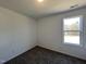 Bright bedroom with carpet flooring and a window offering natural light at 175 W Saltgrass Ln, Smithfield, NC 27577