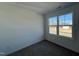 Simple bedroom with gray carpeting and a window overlooking the street at 175 W Saltgrass Ln, Smithfield, NC 27577