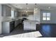 Modern kitchen with gray cabinets, granite countertops, and a kitchen island at 175 W Saltgrass Ln, Smithfield, NC 27577