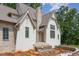 Home exterior featuring white brick and stone accents at 222 Kenwood Ln, Pittsboro, NC 27312