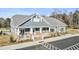 Community clubhouse with brick accents and welcoming porch at 353 Village Walk Dr, Clayton, NC 27527