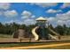 Community playground with playset, climbing wall, and bench at 13 Blackhorn Ct, Pittsboro, NC 27312