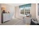 Well-lit bedroom with large window and dresser at 410 Leven Dr, Gibsonville, NC 27249
