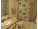 Clean bathroom with a shower/tub combination, and colorful shower curtain at 1525 Marshburn Rd, Wendell, NC 27591