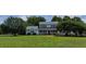 Two-story house with a large front yard, featuring a spacious porch and mature trees at 1525 Marshburn Rd, Wendell, NC 27591