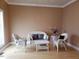Living room with light walls, hardwood floors, and wicker furniture at 1525 Marshburn Rd, Wendell, NC 27591