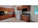 Classic kitchen with wood cabinets, tile backsplash, and built-in appliances at 1525 Marshburn Rd, Wendell, NC 27591