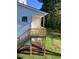 Elevated wooden deck with stairs leading down to the yard at 201 N Smith St, Clayton, NC 27520