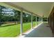 Covered porch overlooking a pond and lush green landscape at 8246 Us-401, Fuquay Varina, NC 27526