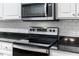 Close-up of kitchen's stainless steel stove top and microwave at 8246 Us-401, Fuquay Varina, NC 27526