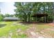 House and large backyard with a wooden shelter in the trees at 8246 Us-401, Fuquay Varina, NC 27526