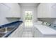Laundry room features a large window, ample counter space, and a deep sink at 8246 Us-401, Fuquay Varina, NC 27526