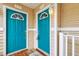 Two teal-colored front doors of a condo building at 333 Glenolden Ct, Cary, NC 27513