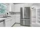 Modern kitchen with white cabinets and stainless steel appliances at 333 Glenolden Ct, Cary, NC 27513