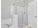 Glass-enclosed shower with white tile surround at 333 Glenolden Ct, Cary, NC 27513