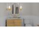 Powder room with wood vanity, gold fixtures, and arched mirror at 2646 Marchmont St, Raleigh, NC 27608