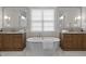 Elegant bathroom with double vanities, a freestanding tub, and marble flooring at 2646 Marchmont St, Raleigh, NC 27608