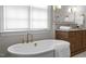 Spa-like bathroom with a freestanding tub and wood vanity at 2646 Marchmont St, Raleigh, NC 27608