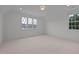 Bright bedroom with carpet flooring and two windows at 2646 Marchmont St, Raleigh, NC 27608