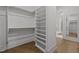 Large walk-in closet with custom shelving and rods at 2646 Marchmont St, Raleigh, NC 27608
