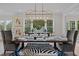 Bright dining room with a large chandelier and window views at 2646 Marchmont St, Raleigh, NC 27608