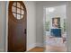 Elegant entryway with arched wood door and view into sunroom at 2646 Marchmont St, Raleigh, NC 27608