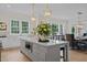 Bright kitchen boasts a large island, white cabinets, and stainless steel appliances at 2646 Marchmont St, Raleigh, NC 27608