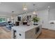 Open kitchen with island, breakfast bar, and views into adjacent living area at 2646 Marchmont St, Raleigh, NC 27608