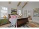 Main bedroom with high ceilings, exposed beams, and a large bed at 2646 Marchmont St, Raleigh, NC 27608