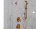 Luxurious shower with marble tile and gold fixtures at 2646 Marchmont St, Raleigh, NC 27608