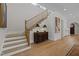 Elegant staircase with wooden banister and neutral tones at 2646 Marchmont St, Raleigh, NC 27608