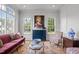 Bright sunroom with large windows, comfortable seating, and statement art at 2646 Marchmont St, Raleigh, NC 27608