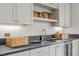 Stylish wet bar with gray countertop, cabinets, and wine cooler at 2646 Marchmont St, Raleigh, NC 27608