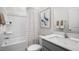 Clean bathroom with white tub and gray vanity at 752 Dorset Stream Dr, Fuquay Varina, NC 27526