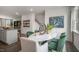 Elegant dining area, marble table with green chairs and kitchen view at 752 Dorset Stream Dr, Fuquay Varina, NC 27526