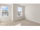 Bright bedroom with two large windows and neutral carpeting at 209 River Bank Rd, Fuquay Varina, NC 27526