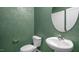 Powder room with green textured walls and a round mirror at 756 Dorset Stream Dr, Fuquay Varina, NC 27526
