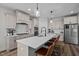 Modern kitchen with white cabinets, quartz countertops, and island seating at 36 Whitehall Dr, Pittsboro, NC 27312