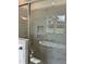 Shower with marble tile, built-in shelves, and a window at 0 Will Suitt Rd, Butner, NC 27522