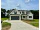 Two-story farmhouse with gray exterior and large driveway at 0 Will Suitt Rd, Butner, NC 27522