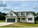 Two-story farmhouse with gray exterior and landscaping at 0 Will Suitt Rd, Butner, NC 27522