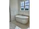 Free-standing bathtub with marble tile and large window at 0 Will Suitt Rd, Butner, NC 27522