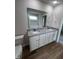Bathroom with double vanity and large mirror at 32 Oakfield Trace Dr, Four Oaks, NC 27524