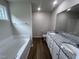 Double vanity bathroom with granite countertop and garden tub at 32 Oakfield Trace Dr, Four Oaks, NC 27524