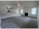 Open living room with a fireplace, kitchen island, and vaulted ceiling at 32 Oakfield Trace Dr, Four Oaks, NC 27524