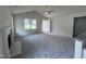 Living room featuring a fireplace, vaulted ceiling and grey carpet at 32 Oakfield Trace Dr, Four Oaks, NC 27524